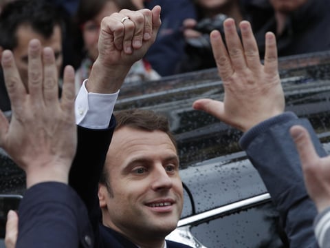 French independent centrist presidential candidate Emmanuel Macron waves as he leaves the polling station in Le Touquet, France, Sunday. Macron was declared the winner based on early vote counts by the French Interior Ministry.